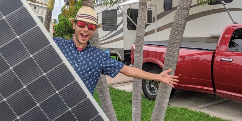 tom holding solar panel