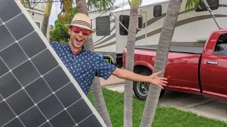 tom holding solar panel