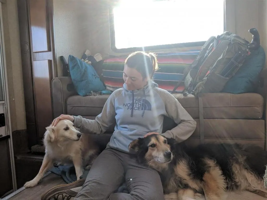 Cait on floor of lance 1172 truck camper with dogs