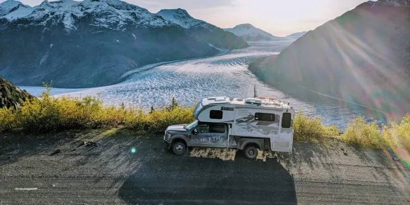 off road truck camper in front of glacier