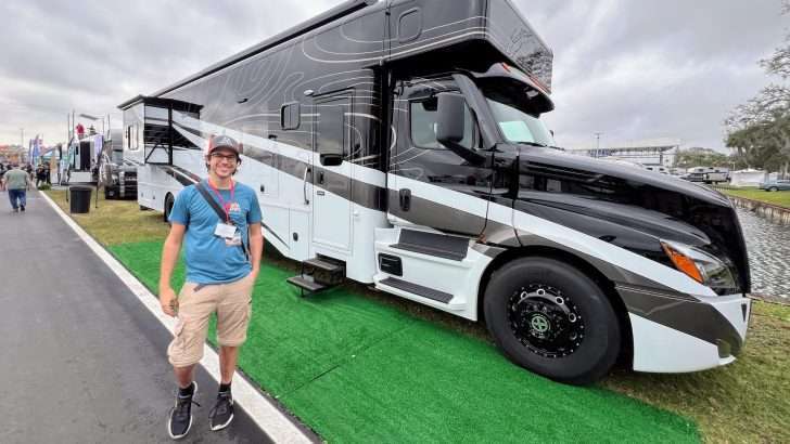tom standing in front of a super c rv