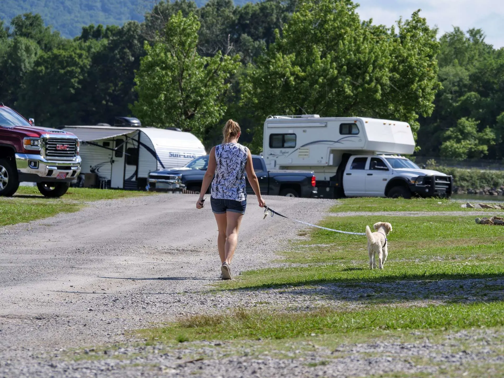 woman walking dog through campground