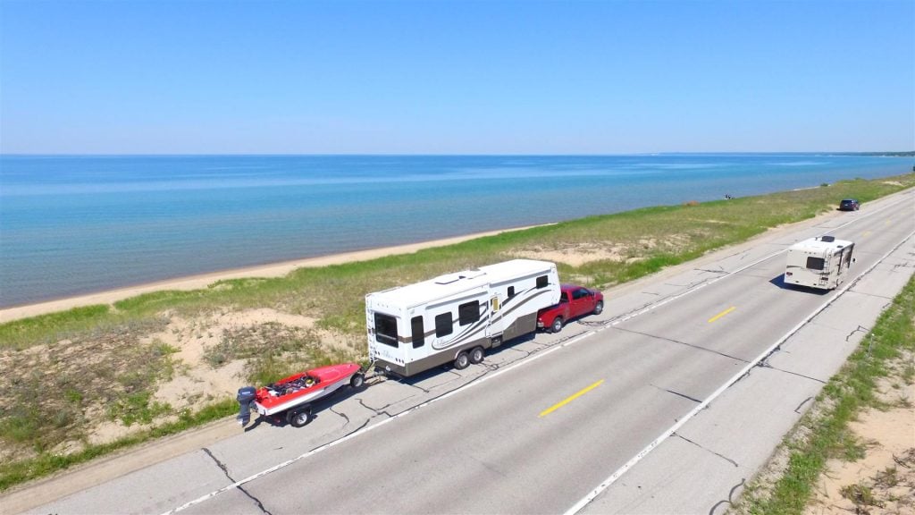triple towing a boat behind a fifth wheel rv trailer