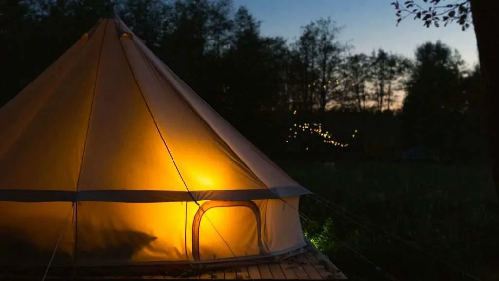 glamping tent glowing at night