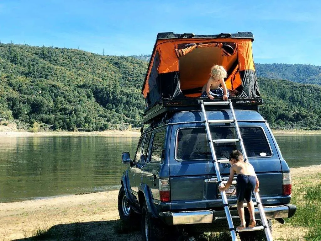 suv tent on roof of car at lake