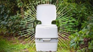 portable camping toilet in woods