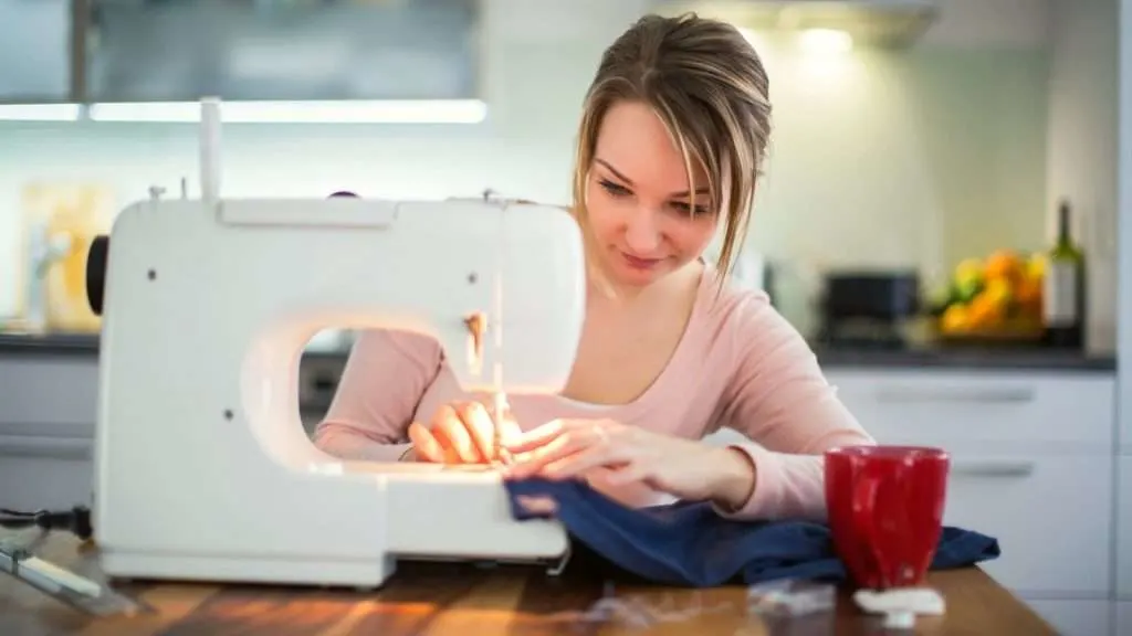 Woman sewing fabric with sewing machine