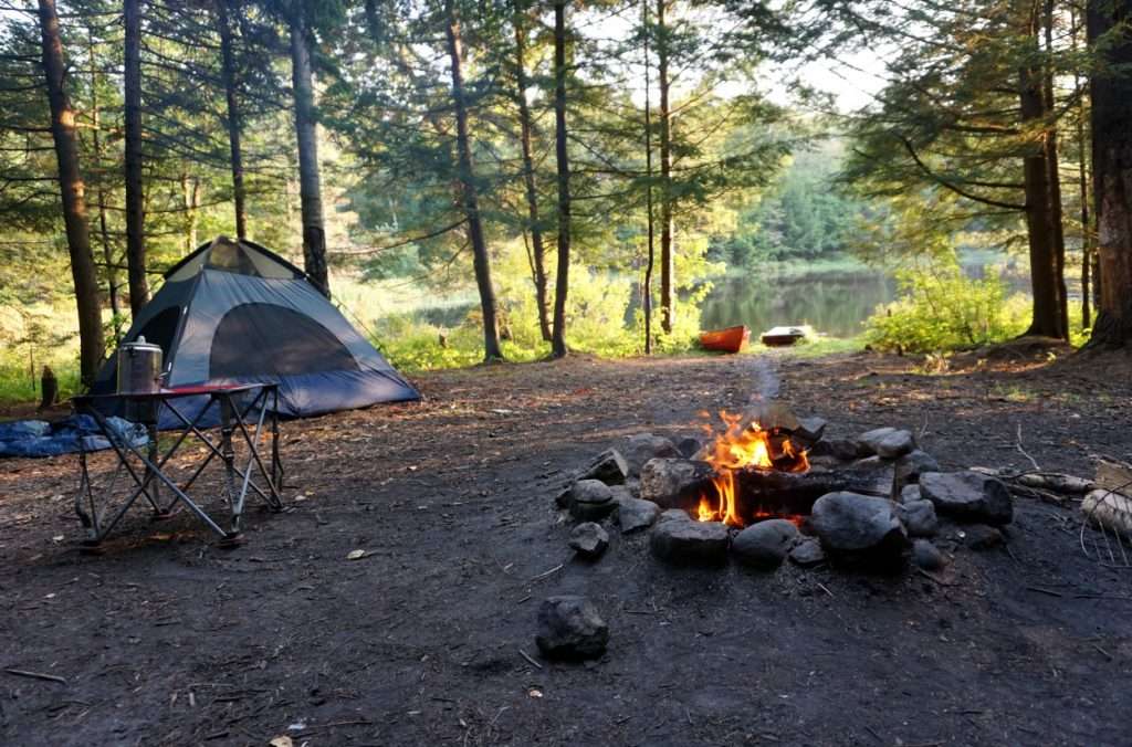 campfire and tent in campsite