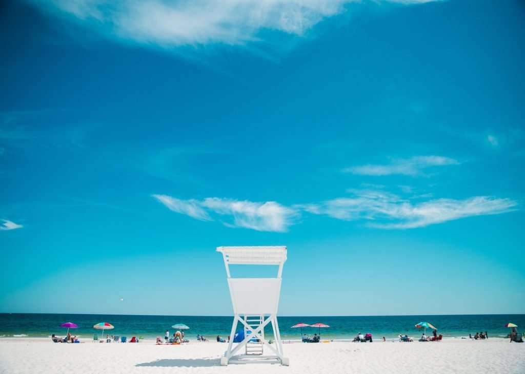 White sandy beach in Gulf Coast of Florida. Lifeguard chair overlooking the beach.