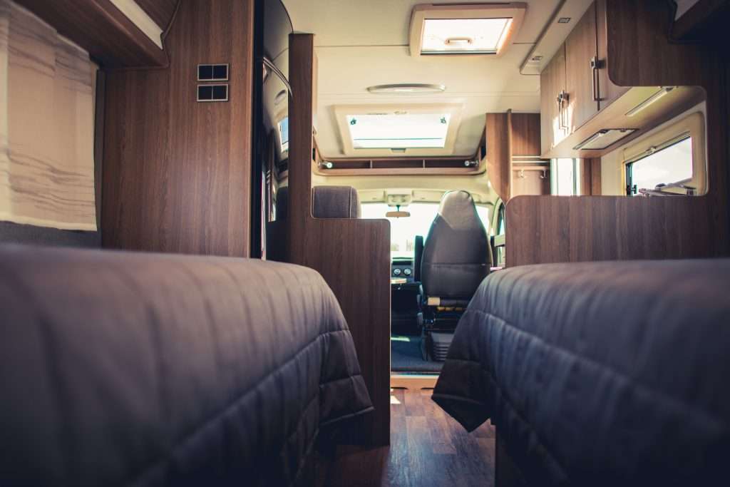 Inside of RV home from bed to front passenger seat.