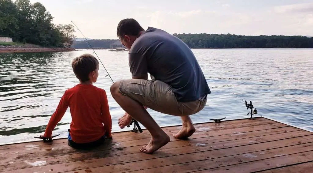 Dad and son fishing together.