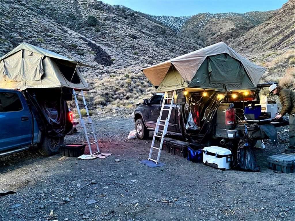 Two overlanding vehicles setting up camp.