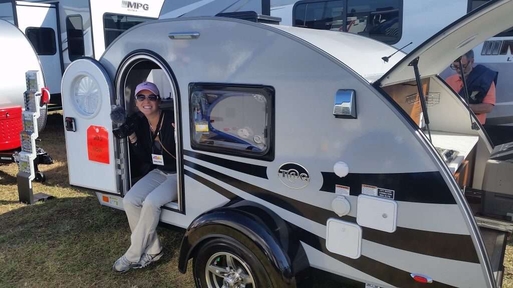 Caitlin from Mortons on the Move in a small camper.