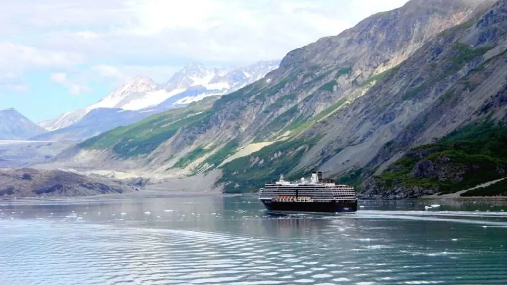 Alaska cruise ship with mountainous landscape in background