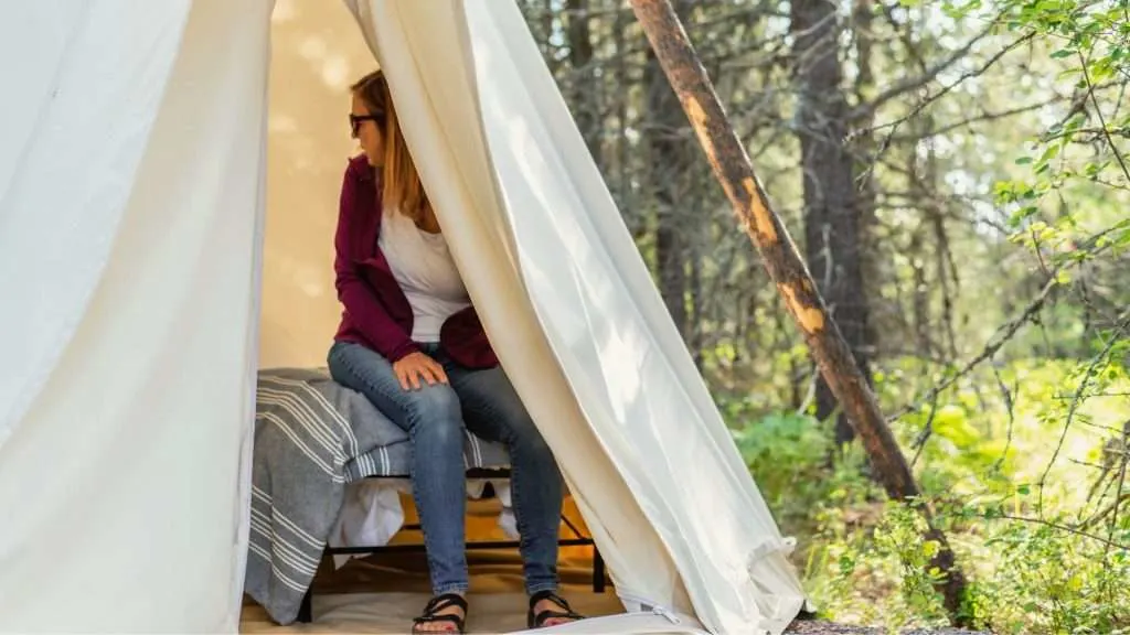 Woman sitting on a camping cot