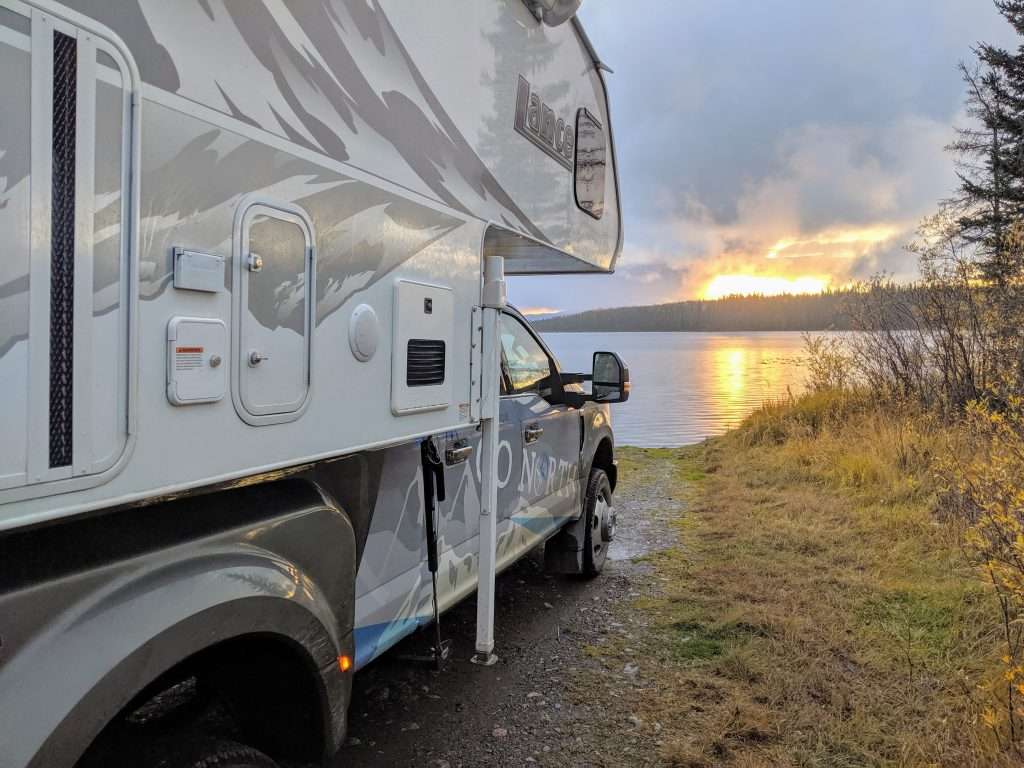 truck camper parked near a lake