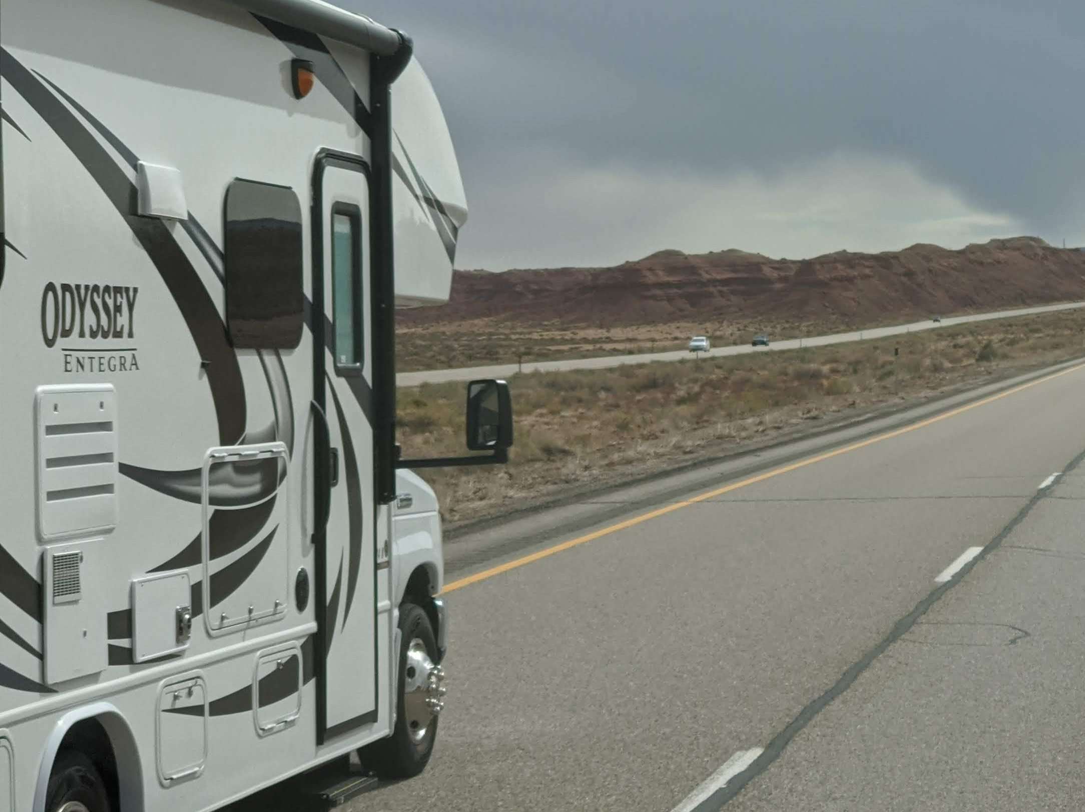 RV driving on highway with frameless window