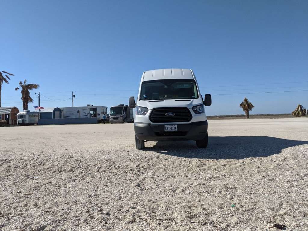 Ford transit van parked on the beach