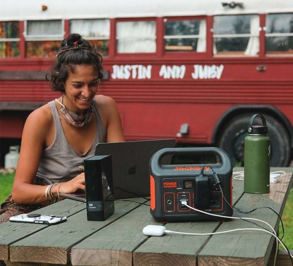 Woman using laptop connected to her Jackery.