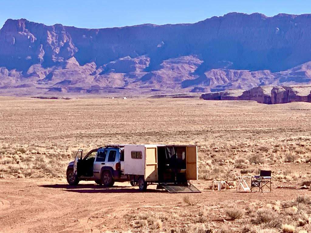 Truck and trailer set up in desert for boondocking.