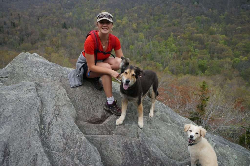Cait hiking with two dogs.