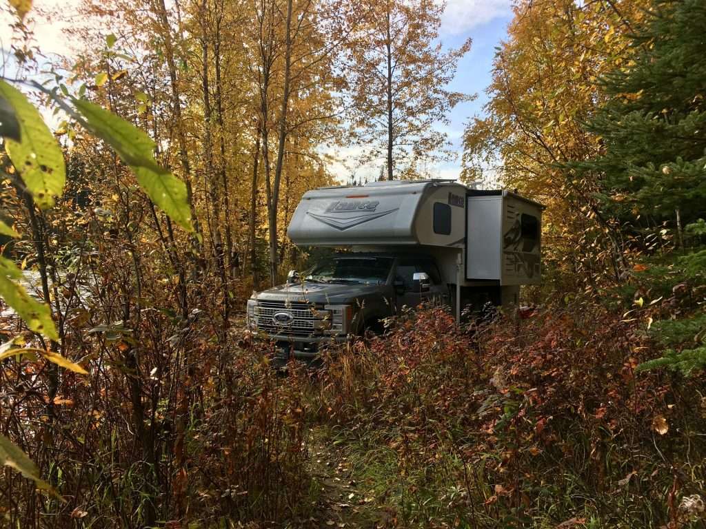 Mortons on the Move truck camper overlanding through forests.