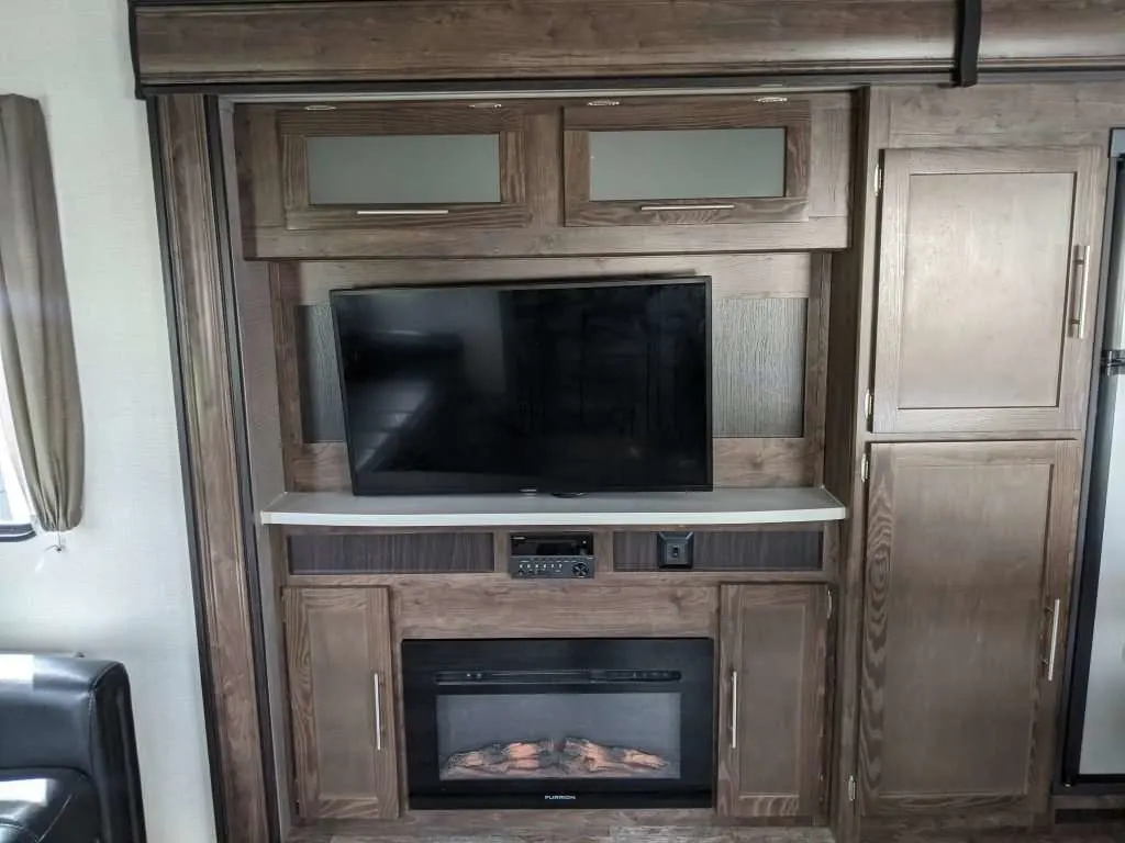 RV fireplace with TV above it.