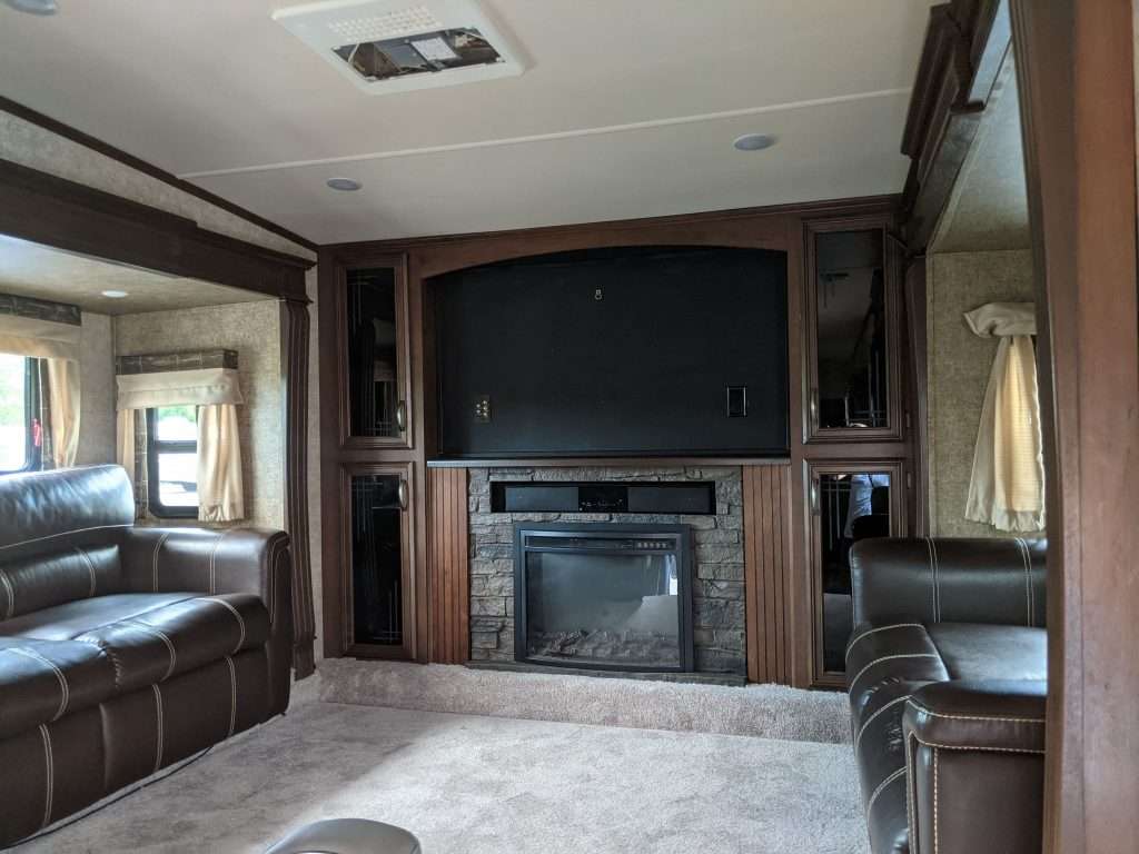 RV living room with fireplace inside.