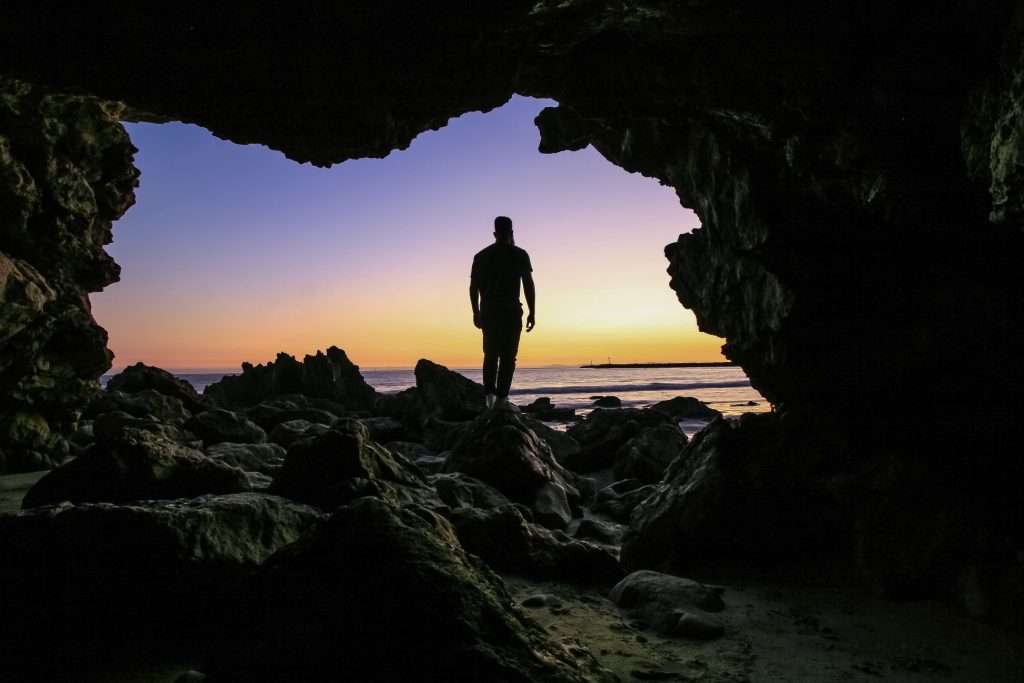 Man exploring cove in California.