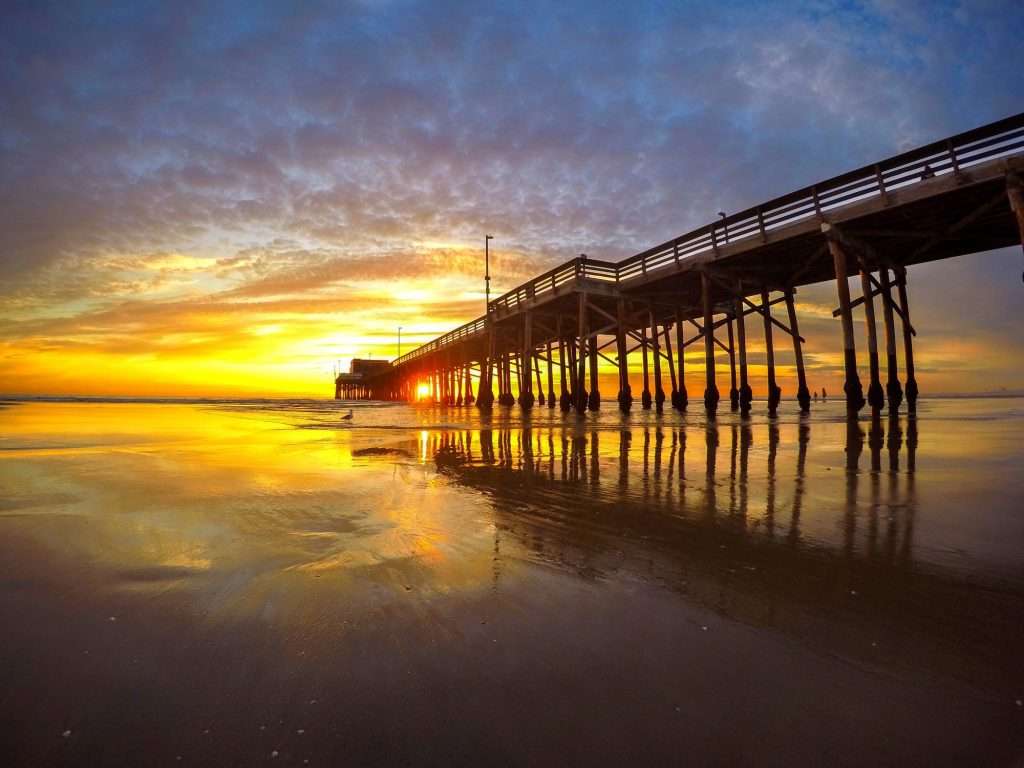 California beach with pier at sunrise.