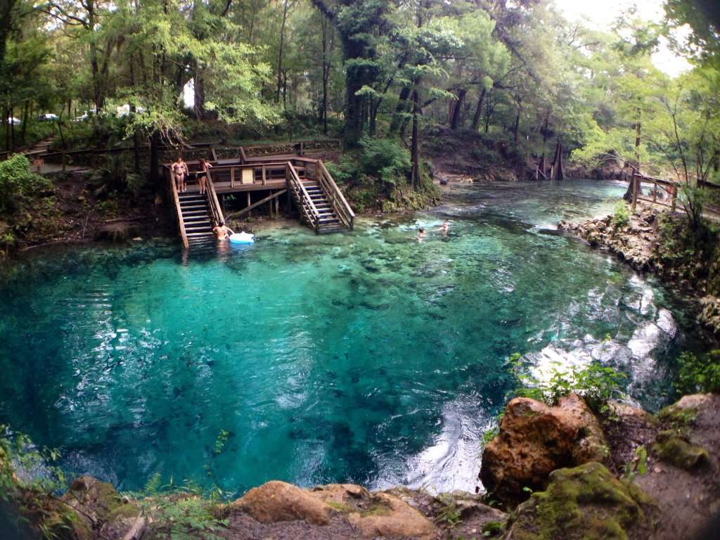 People climbing into swimming hole in Florida Springs.