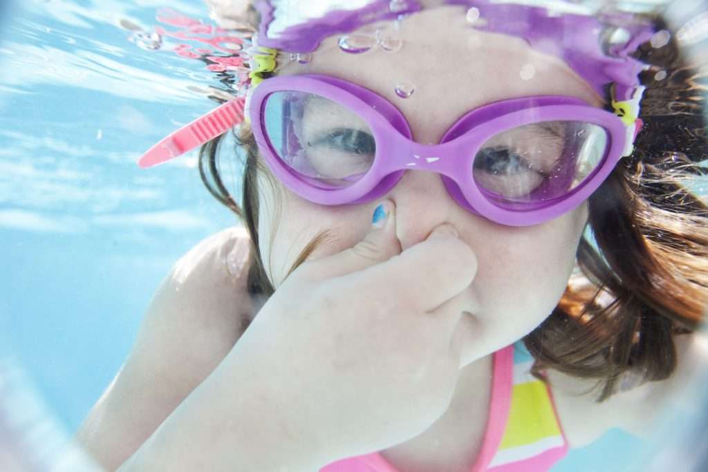 Little girl swimming under water
