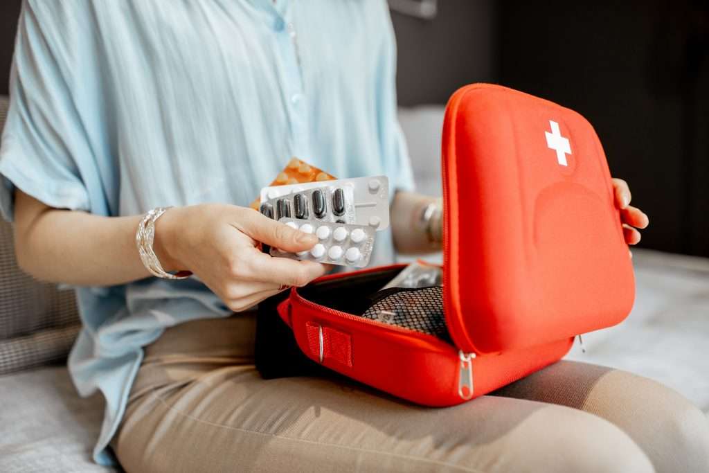 Woman looking through first aid kit