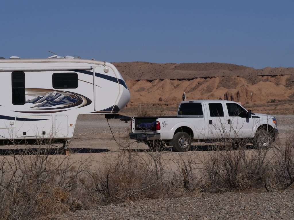 Truck and fifth wheel parked for boondocking.