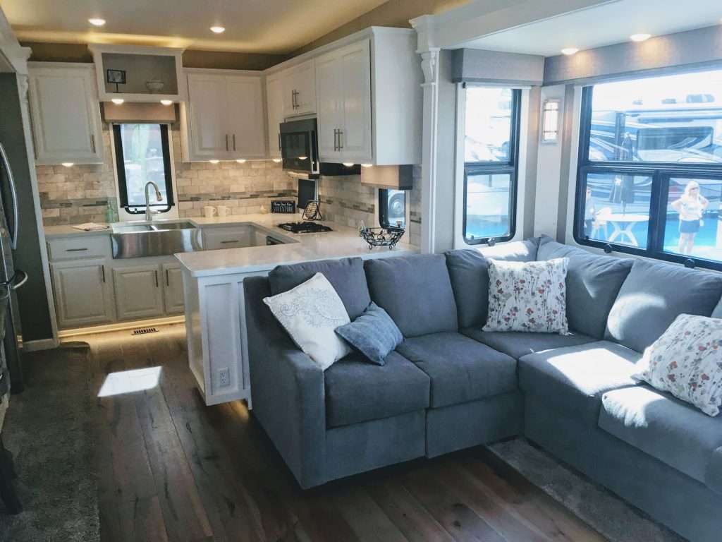 rear kitchen fifth wheel with large sofa in living room