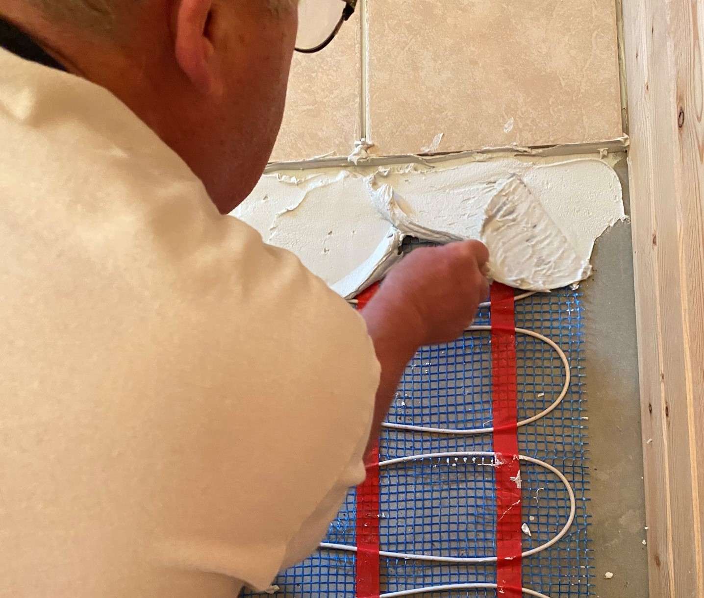 Man installing heated floors