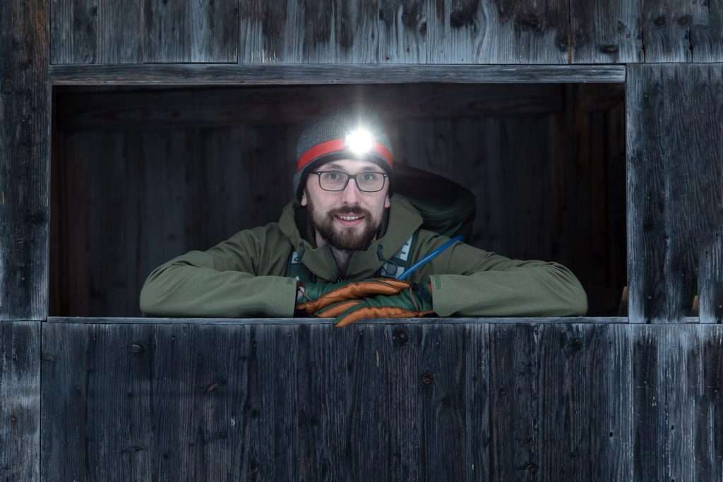 Man posing with head lamp on.