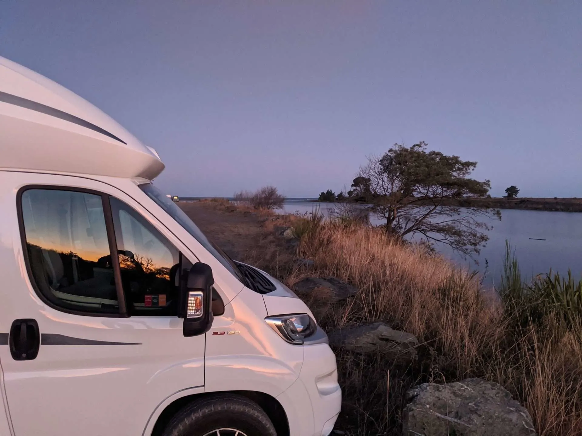 RV parked along water