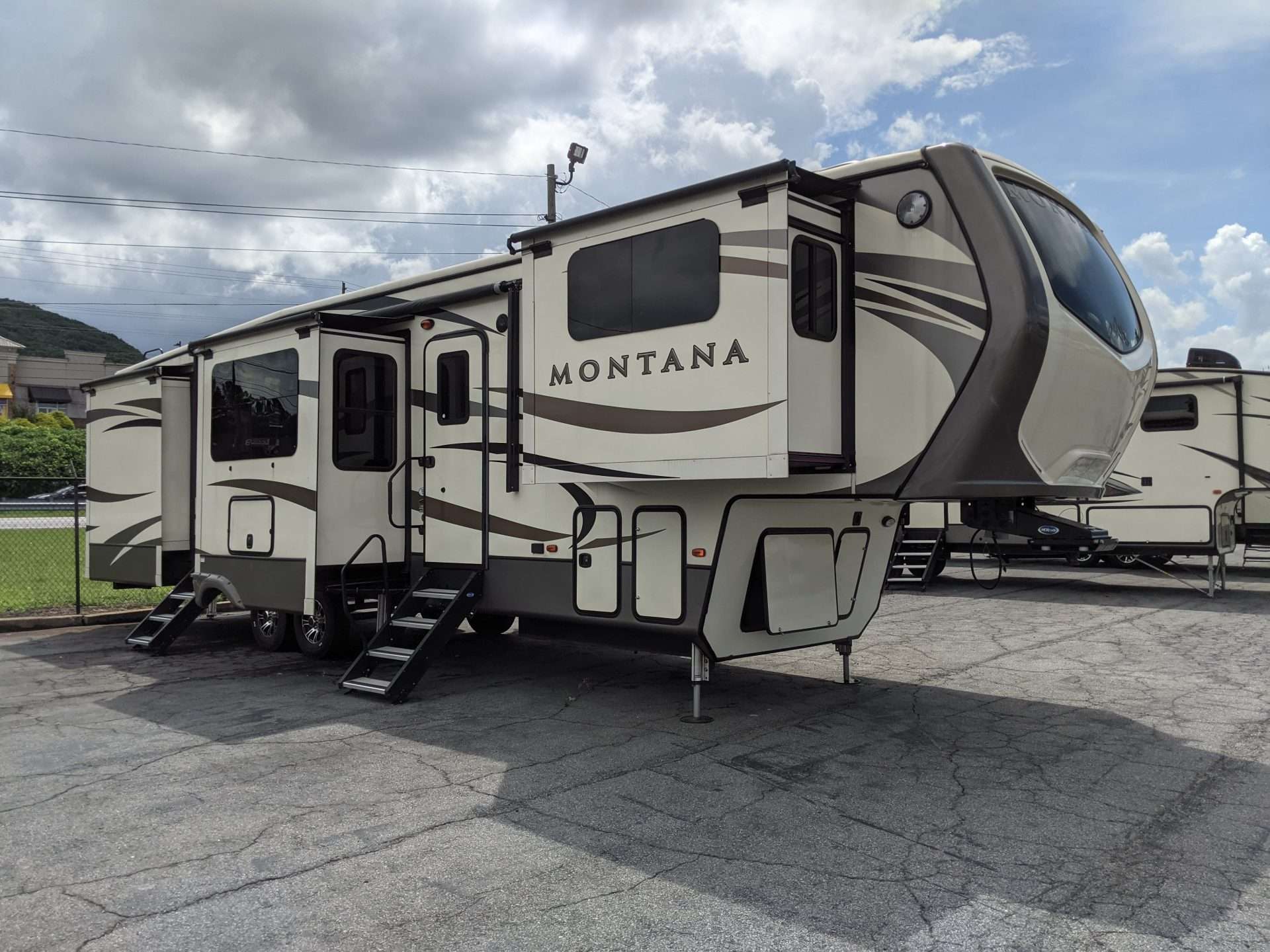 Montana 5th wheel parked in parking lot.