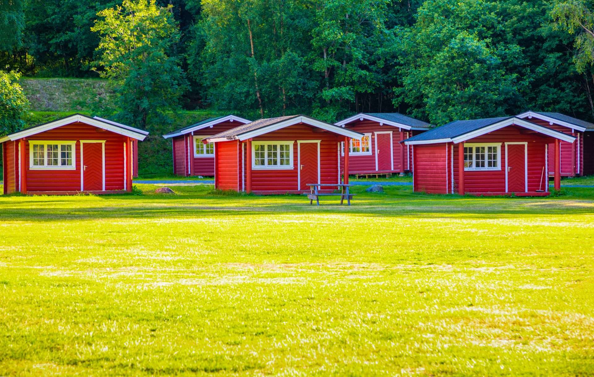 Red cabins lined up at campsite.