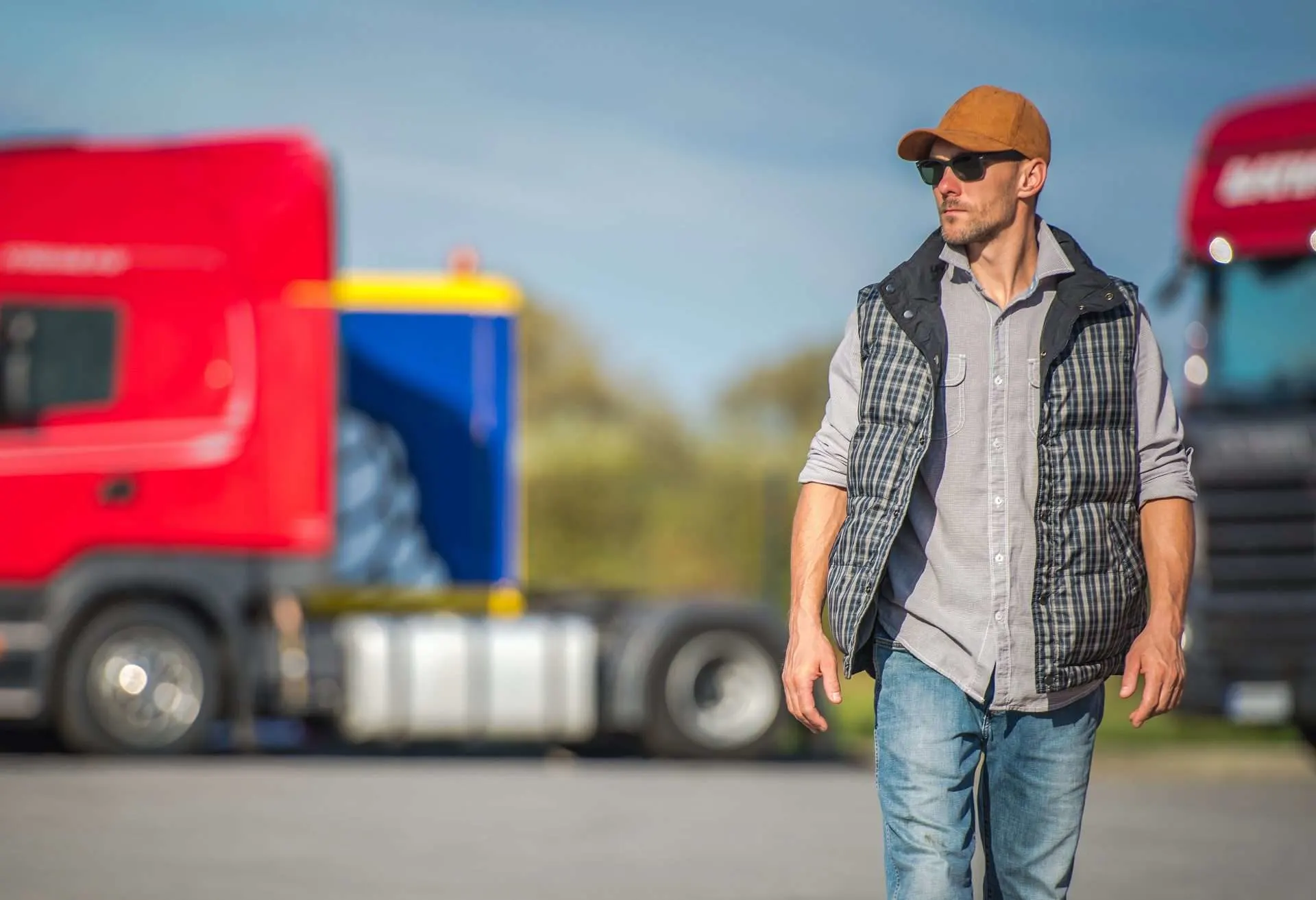 Man walking in front of trucks at truck stop