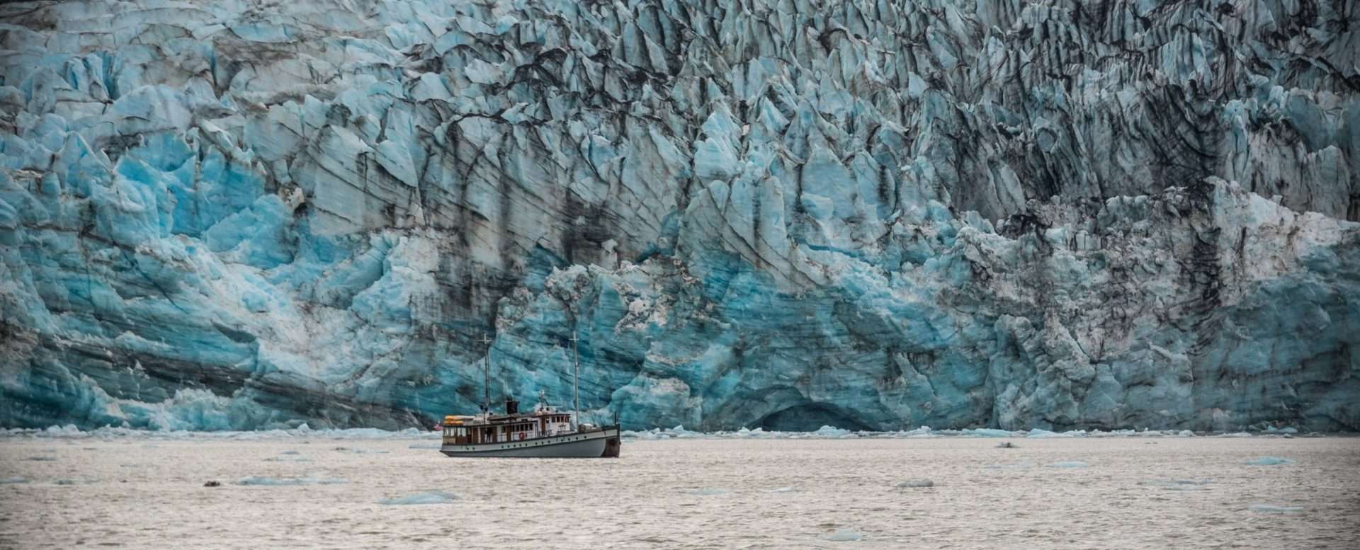 Boat in front of glacier in Glacier Bay National Park.
