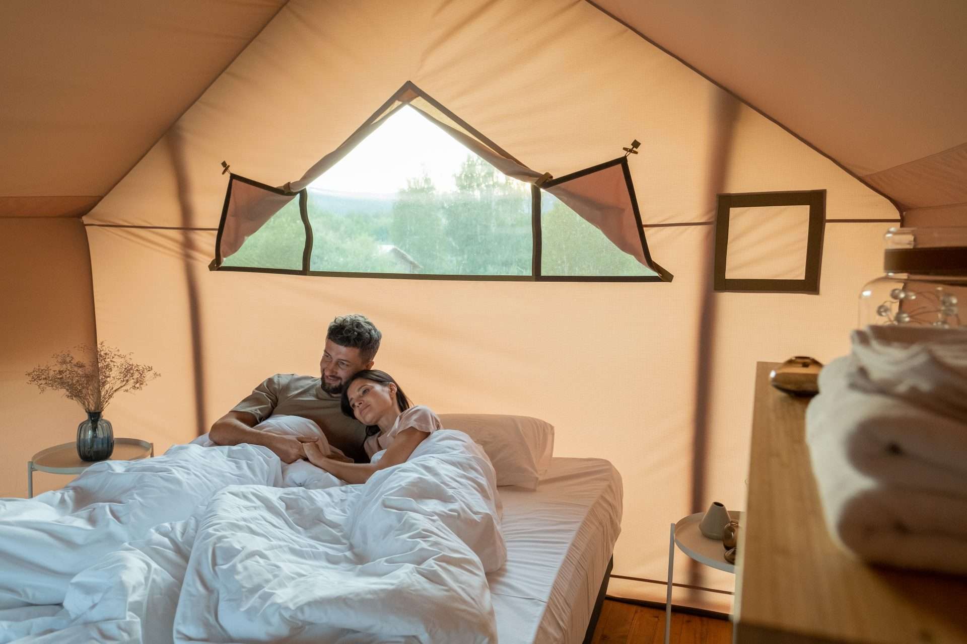 Couple sleeping in a glamping tent