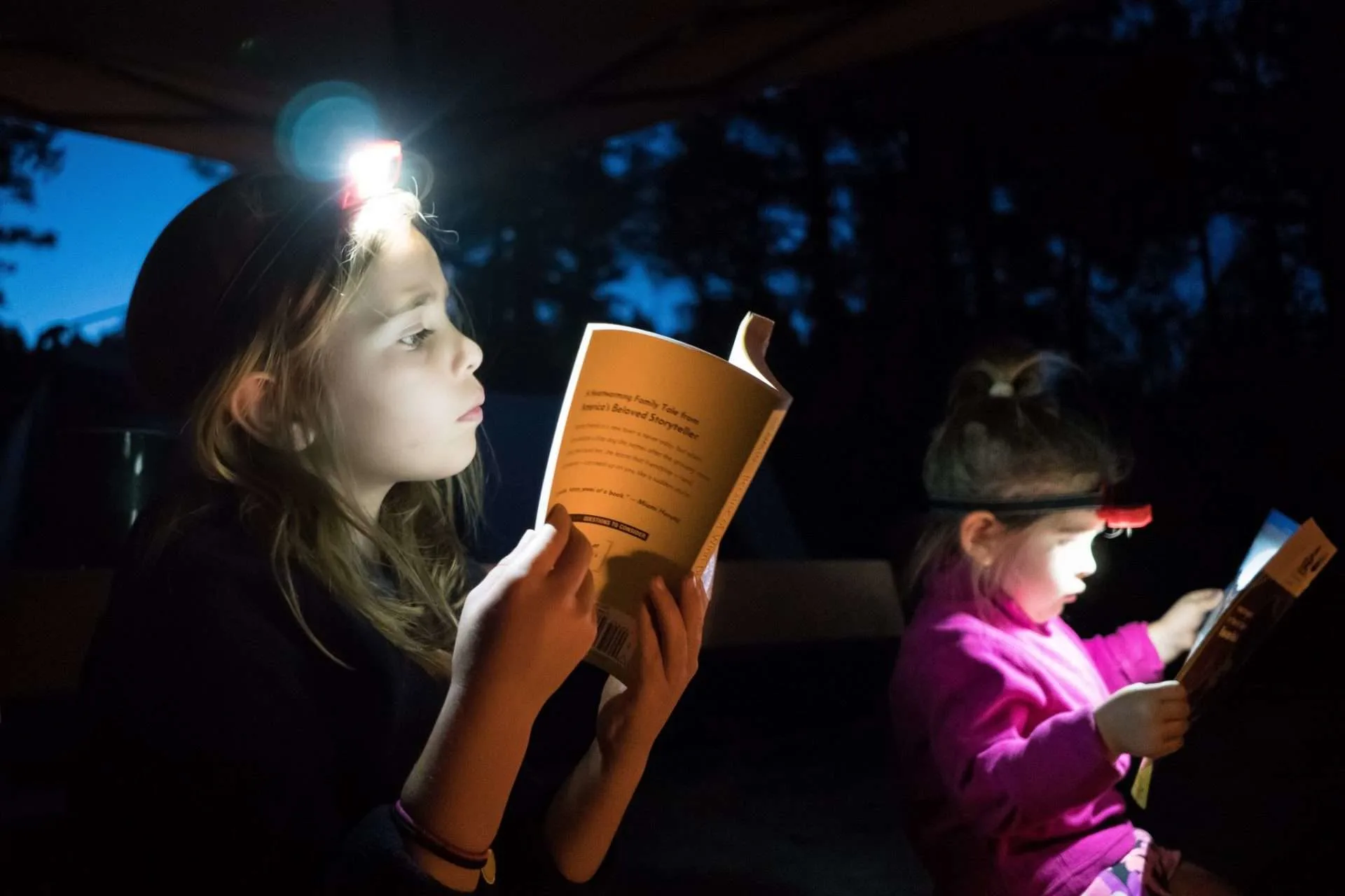 Kids reading in the dark with headlamps
