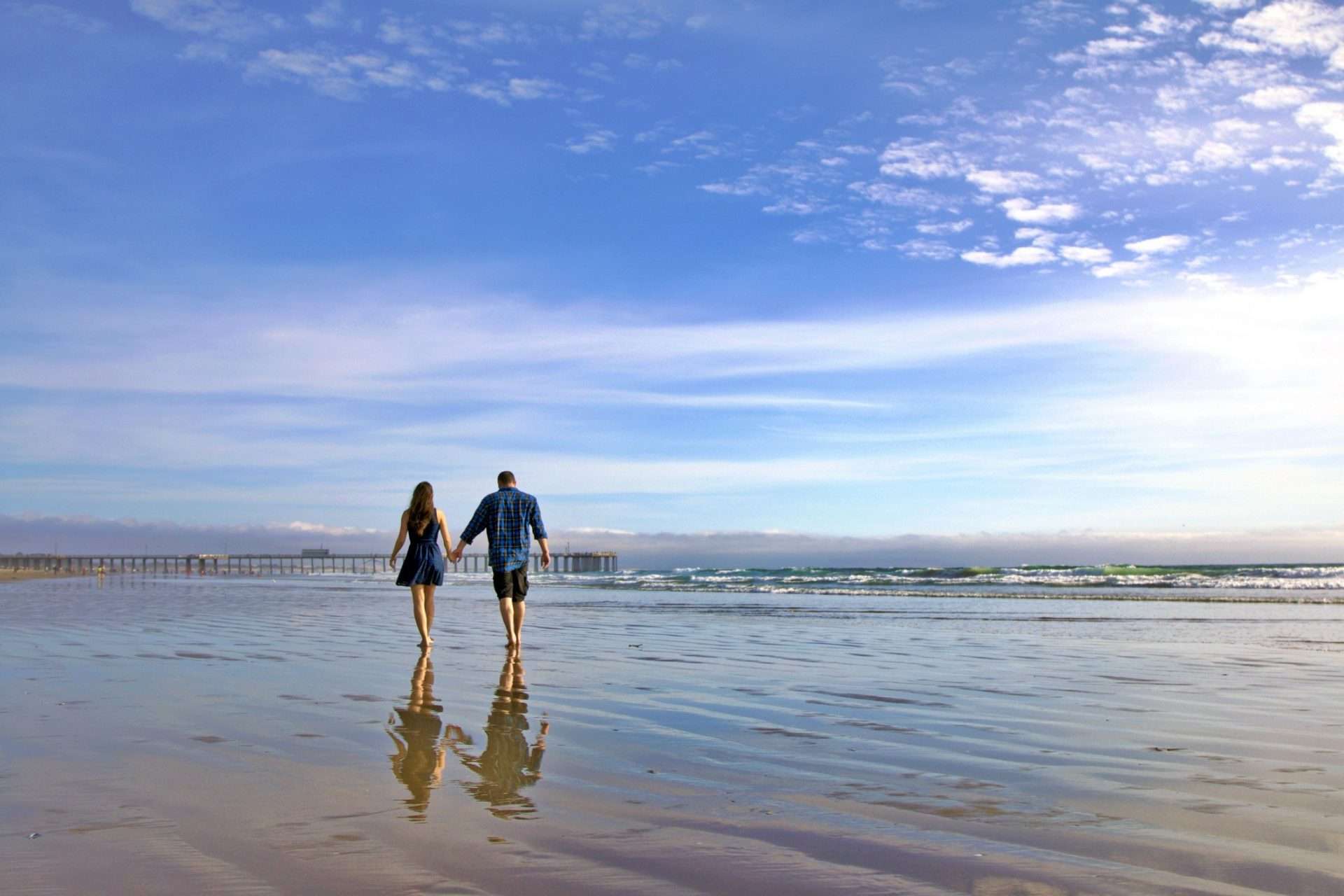 Couple walking together on Pismo Beach.
