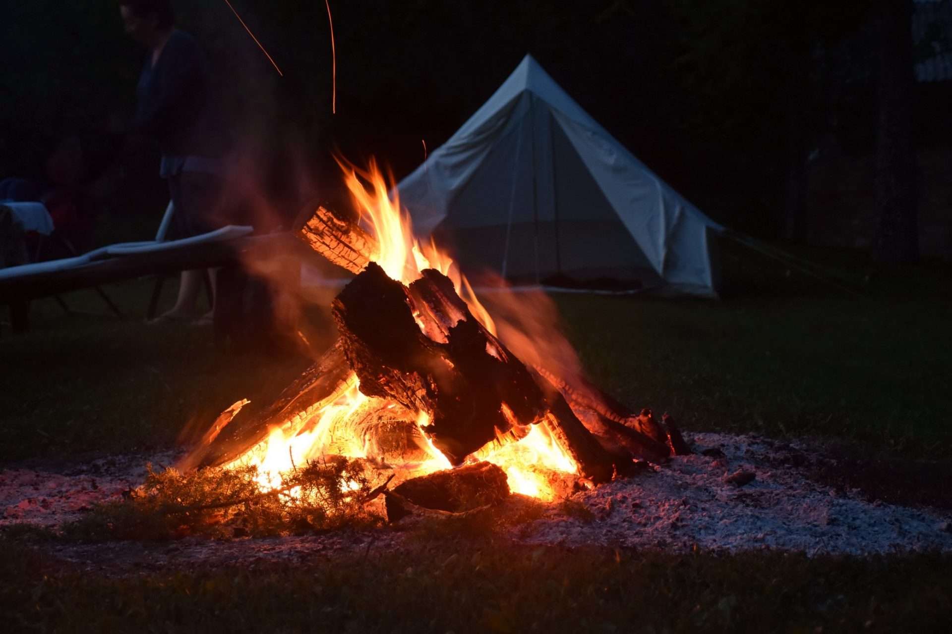 Campfire in front of tent