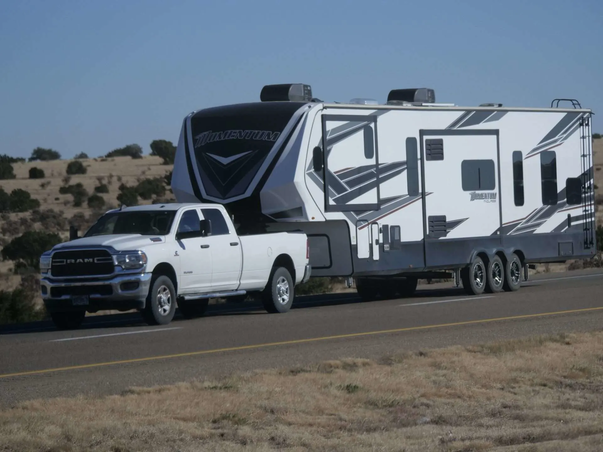 White RAM truck towing fifth wheel