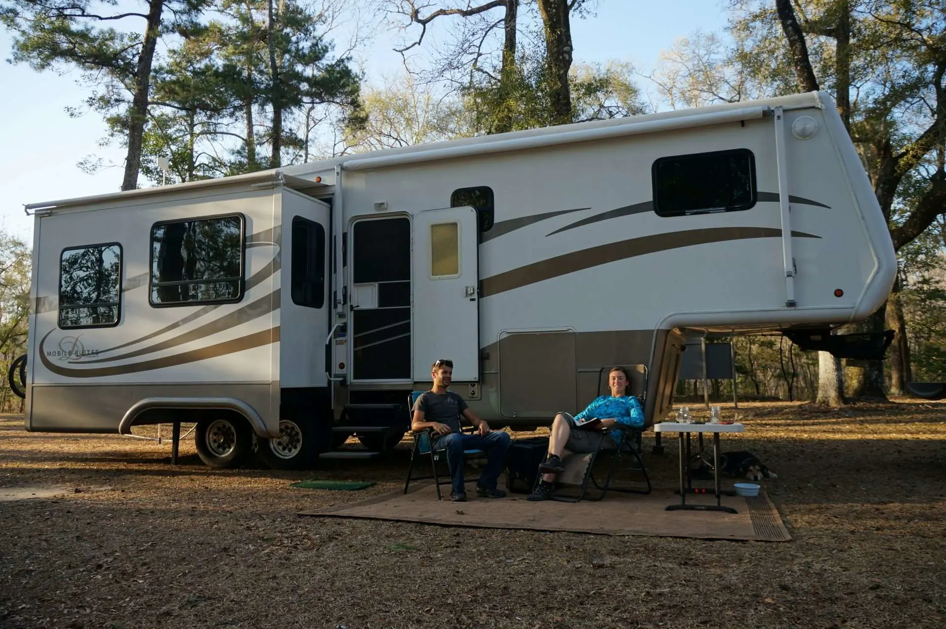 The Mortons sitting in front of their RV at a Florida campsite.