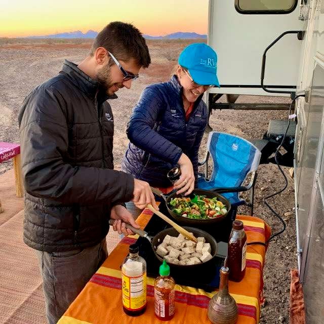 Cait and Tom from Mortons on the Move cooking outside while boondocking.