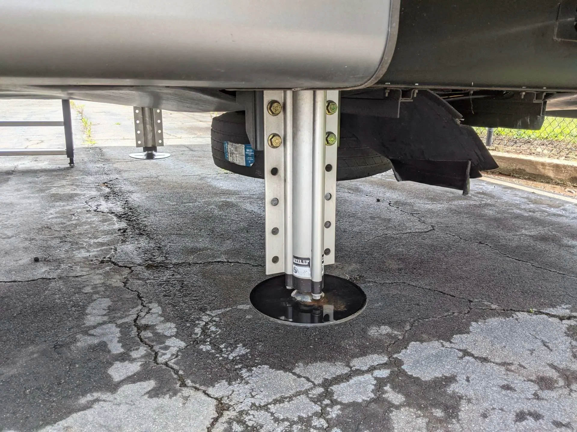 Underneath RV where an RV leveler in place.